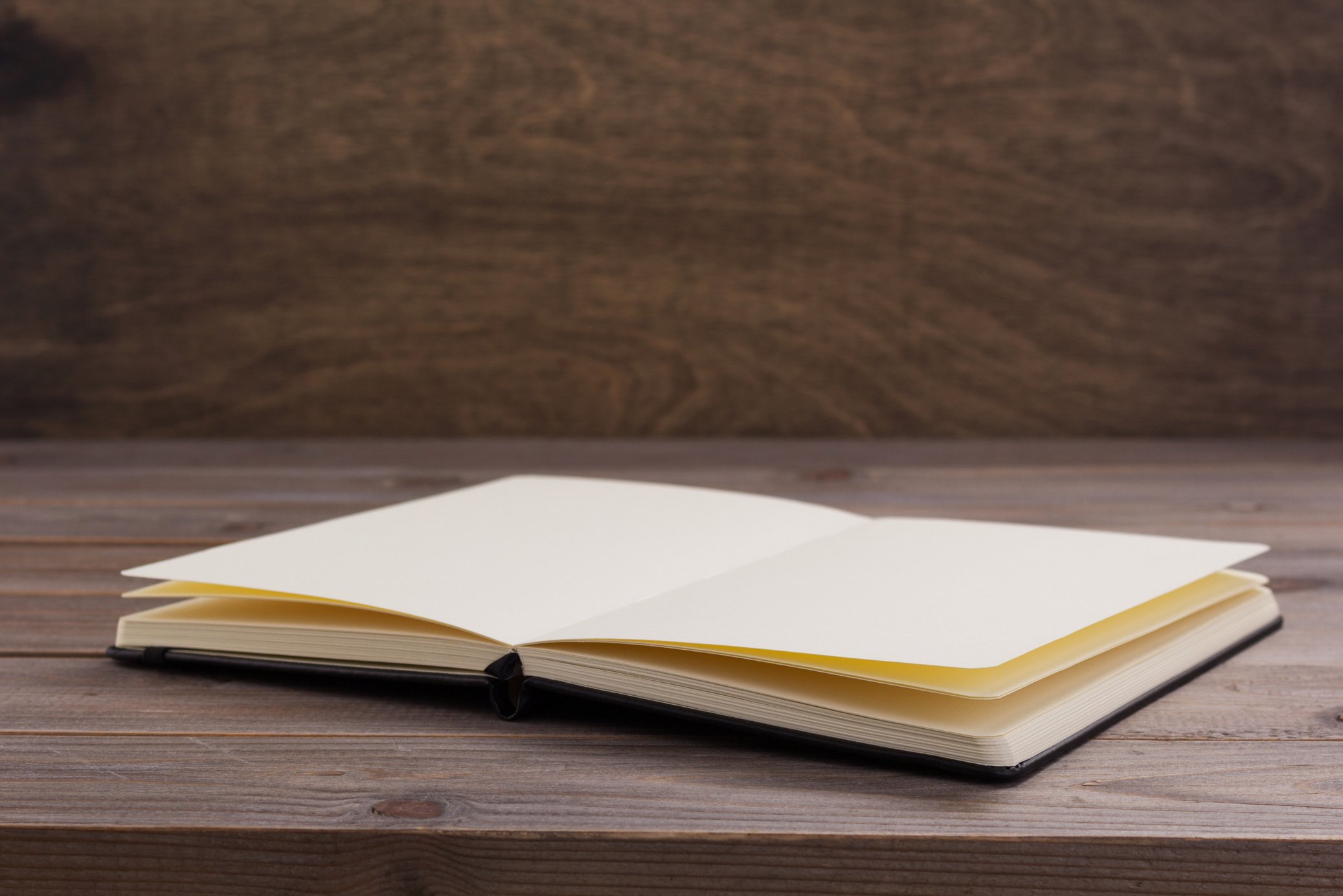 Open Notebook on Wooden Table